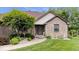 Charming brick home with mature landscaping and well-maintained lawn at 2818 Locust Dr, Indianapolis, IN 46227