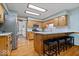 Eat-in kitchen with stainless steel appliances, granite counters, and a breakfast bar at 2818 Locust Dr, Indianapolis, IN 46227