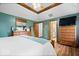 Spacious main bedroom with wood-look flooring, tray ceiling, and ensuite access at 2818 Locust Dr, Indianapolis, IN 46227