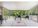 Enclosed sun room with tiled floors, sliding glass doors, and outdoor views at 2818 Locust Dr, Indianapolis, IN 46227