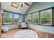 Bright sun room with vaulted ceiling, lots of windows, and wood-look flooring at 2818 Locust Dr, Indianapolis, IN 46227
