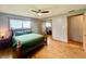 Comfortable bedroom with hardwood floors, ceiling fan, and a mirrored closet at 2833 Desoto Way, Columbus, IN 47203