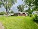 Charming single-story home featuring a brick facade, well-maintained landscaping, and a lush green lawn at 2833 Desoto Way, Columbus, IN 47203