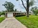 Charming single-story home with a well-maintained lawn and attached garage at 2833 Desoto Way, Columbus, IN 47203