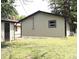 Spacious backyard with a garage and a glimpse of a cozy home exterior; ideal for outdoor activities at 3026 Stuart St, Indianapolis, IN 46218
