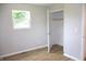Serene bedroom boasting wood flooring, a closet, and a window overlooking a lush green tree at 3026 Stuart St, Indianapolis, IN 46218