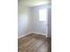 Inviting bedroom enhanced by wood-look flooring, white trim and fresh paint. Natural light from the window at 3026 Stuart St, Indianapolis, IN 46218