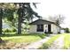 Charming single-story home with light yellow brick, a small garage, and a well-maintained front yard at 3026 Stuart St, Indianapolis, IN 46218