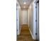 Hallway with wood floors, white doors, and neutral walls leading to various rooms at 3026 Stuart St, Indianapolis, IN 46218