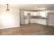 Bright kitchen with white cabinetry, granite counters, modern lighting, and durable wood-look flooring at 3026 Stuart St, Indianapolis, IN 46218