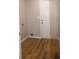Functional laundry room with wood flooring, neutral walls, and access to the exterior at 3026 Stuart St, Indianapolis, IN 46218