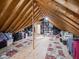Large attic space featuring exposed wooden beams, offering versatile storage and renovation possibilities at 312 Hawthorne Dr, Pittsboro, IN 46167