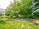 Inviting backyard with garden beds and a mature tree, offering a serene outdoor space at 312 Hawthorne Dr, Pittsboro, IN 46167