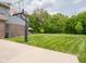 Expansive backyard featuring a basketball hoop and well-manicured lawn, ideal for recreation at 312 Hawthorne Dr, Pittsboro, IN 46167