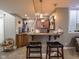 Basement wet bar featuring counter seating, custom cabinetry, and sports-themed decor at 312 Hawthorne Dr, Pittsboro, IN 46167