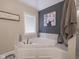 Bathroom featuring a soaking tub, corner windows, and modern fixtures at 312 Hawthorne Dr, Pittsboro, IN 46167