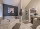 Contemporary bathroom featuring tiled shower, garden tub, and stylish decor at 312 Hawthorne Dr, Pittsboro, IN 46167