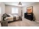 Bedroom with neutral walls and carpet, complemented by a stylish black dresser and decor at 312 Hawthorne Dr, Pittsboro, IN 46167