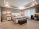 Comfortable primary bedroom with tray ceiling, carpeted floor, large window and natural light at 312 Hawthorne Dr, Pittsboro, IN 46167