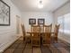 Bright dining room with a large window, wood table and chairs, and neutral wall color at 312 Hawthorne Dr, Pittsboro, IN 46167