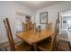Cozy dining room featuring hardwood floors, neutral walls, wood table, and wainscotting at 312 Hawthorne Dr, Pittsboro, IN 46167