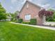 Brick home featuring manicured lawn and landscaping at 312 Hawthorne Dr, Pittsboro, IN 46167