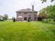 Lovely brick home with a large backyard, patio seating, and mature landscaping at 312 Hawthorne Dr, Pittsboro, IN 46167
