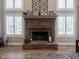 A brick fireplace with white shutters, mantle decor, and hardwood floors at 312 Hawthorne Dr, Pittsboro, IN 46167