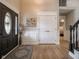 Elegant foyer featuring hardwood floors, decorative trim, and a stylish front door and staircase at 312 Hawthorne Dr, Pittsboro, IN 46167
