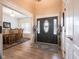 Bright foyer featuring hardwood floors, decorative trim, and a stylish front door with glass panels at 312 Hawthorne Dr, Pittsboro, IN 46167