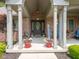 Inviting front entryway with a brick facade and welcoming porch with decorative plants and seating at 312 Hawthorne Dr, Pittsboro, IN 46167