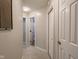 Hallway with three doors and neutral paint is well lit with recessed lighting at 312 Hawthorne Dr, Pittsboro, IN 46167