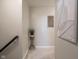 Neutral hallway enhanced by artwork and a decorative plant offers a tranquil transition between rooms at 312 Hawthorne Dr, Pittsboro, IN 46167