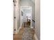 Hallway with hardwood floors leading to the dining room with natural light at 312 Hawthorne Dr, Pittsboro, IN 46167