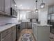 Gray kitchen with subway tile backsplash, stainless appliances, and granite countertops at 312 Hawthorne Dr, Pittsboro, IN 46167