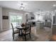 Modern kitchen and open dining area with light gray cabinets and stainless steel appliances at 312 Hawthorne Dr, Pittsboro, IN 46167