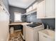 Well-organized laundry room with washer, dryer, utility sink, shelving, and ample storage at 312 Hawthorne Dr, Pittsboro, IN 46167