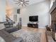 Spacious living room with a ceiling fan, gray sectional sofa, and decorative rug at 312 Hawthorne Dr, Pittsboro, IN 46167