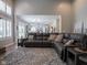 Spacious living room featuring hardwood floors, a stylish area rug, and a view of the kitchen at 312 Hawthorne Dr, Pittsboro, IN 46167