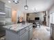 Bright, open-concept living space boasts modern lighting, granite countertops, stainless steel appliances and cozy fireplace at 312 Hawthorne Dr, Pittsboro, IN 46167