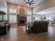 Spacious living room featuring a brick fireplace, hardwood floors, and a ceiling fan at 312 Hawthorne Dr, Pittsboro, IN 46167