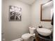 Stylish powder room features a vessel sink, elegant mirror, and sophisticated wall art at 312 Hawthorne Dr, Pittsboro, IN 46167