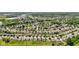 Areal view showing homes in a neighborhood with trees, ponds, and green grass at 3349 Capsella Ln, Indianapolis, IN 46203
