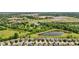 An aerial view of a residential neighborhood with a pond and beautiful landscaping at 3349 Capsella Ln, Indianapolis, IN 46203