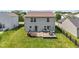 Aerial backyard view of a two-story house with a wooden deck, an umbrella and green grass at 3349 Capsella Ln, Indianapolis, IN 46203