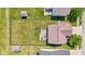 Aerial view of the backyard with a deck, green lawn, privacy fence, and storage sheds at 3349 Capsella Ln, Indianapolis, IN 46203