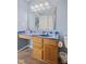 Compact bathroom with a blue counter and a wooden vanity, toilet, and tile flooring at 3349 Capsella Ln, Indianapolis, IN 46203