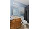 Practical bathroom featuring a vanity, mirror, toilet, and a shower with a dark shower curtain at 3349 Capsella Ln, Indianapolis, IN 46203