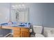 Compact bathroom with a blue counter and a single sink vanity, toilet and lots of open space at 3349 Capsella Ln, Indianapolis, IN 46203