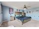 This charming bedroom features a ceiling fan, carpet flooring, and a comfortable bed with a blue comforter at 3349 Capsella Ln, Indianapolis, IN 46203